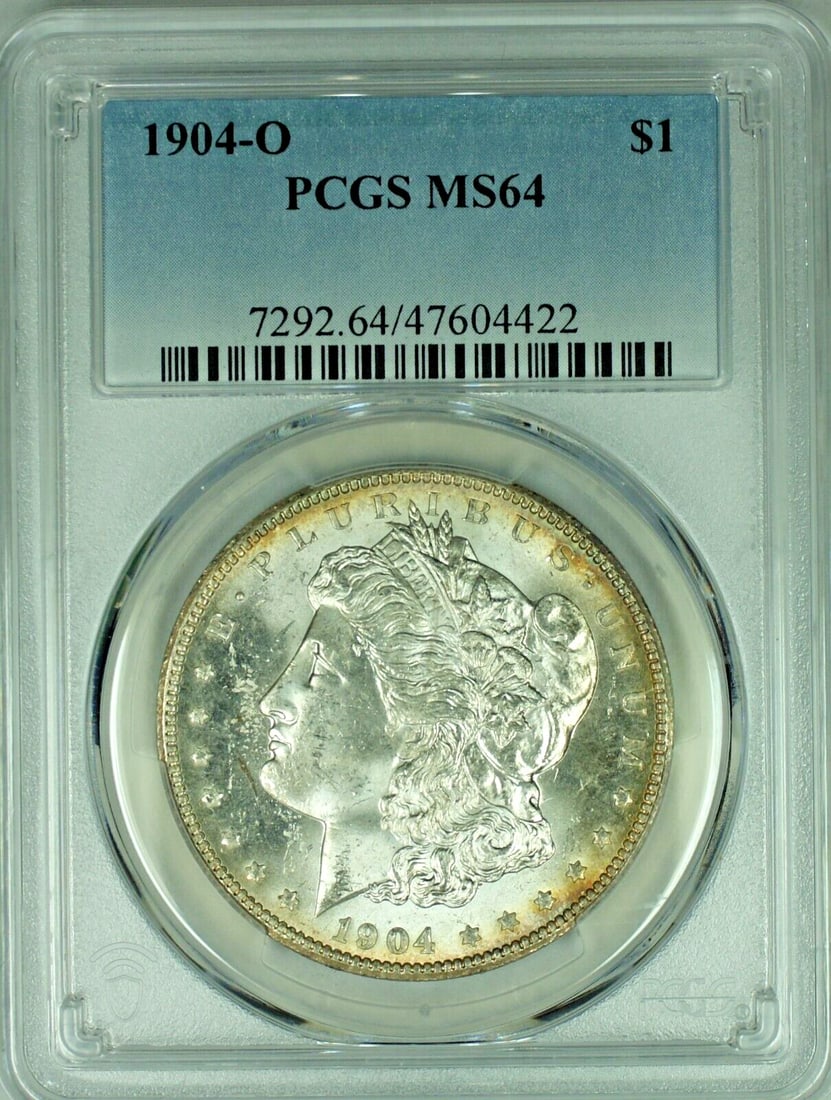 1904-O PCGS MS 64 Morgan Dollar Silver Coin With Toned Reverse: 1904-O PCGS MS 64 Morgan Dollar Silver Coin With Toned Reverse This 1904-O Morgan Silver Dollar is an uncirculated $1 coin with a toned reverse, graded MS 64 and certified by PCGS. It is composed of s