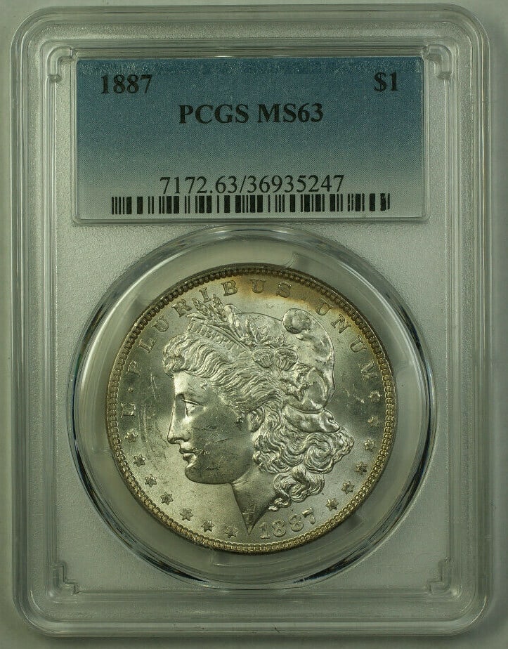 PCGS MS63 1887 Morgan Dollar Silver Coin with Subtle Toning on Reverse: PCGS MS63 1887 Morgan Dollar Silver Coin with Subtle Toning on Reverse This 1887 Morgan Silver Dollar is a $1 coin from the United States, minted in Philadelphia. Certified by PCGS with a grade of MS-