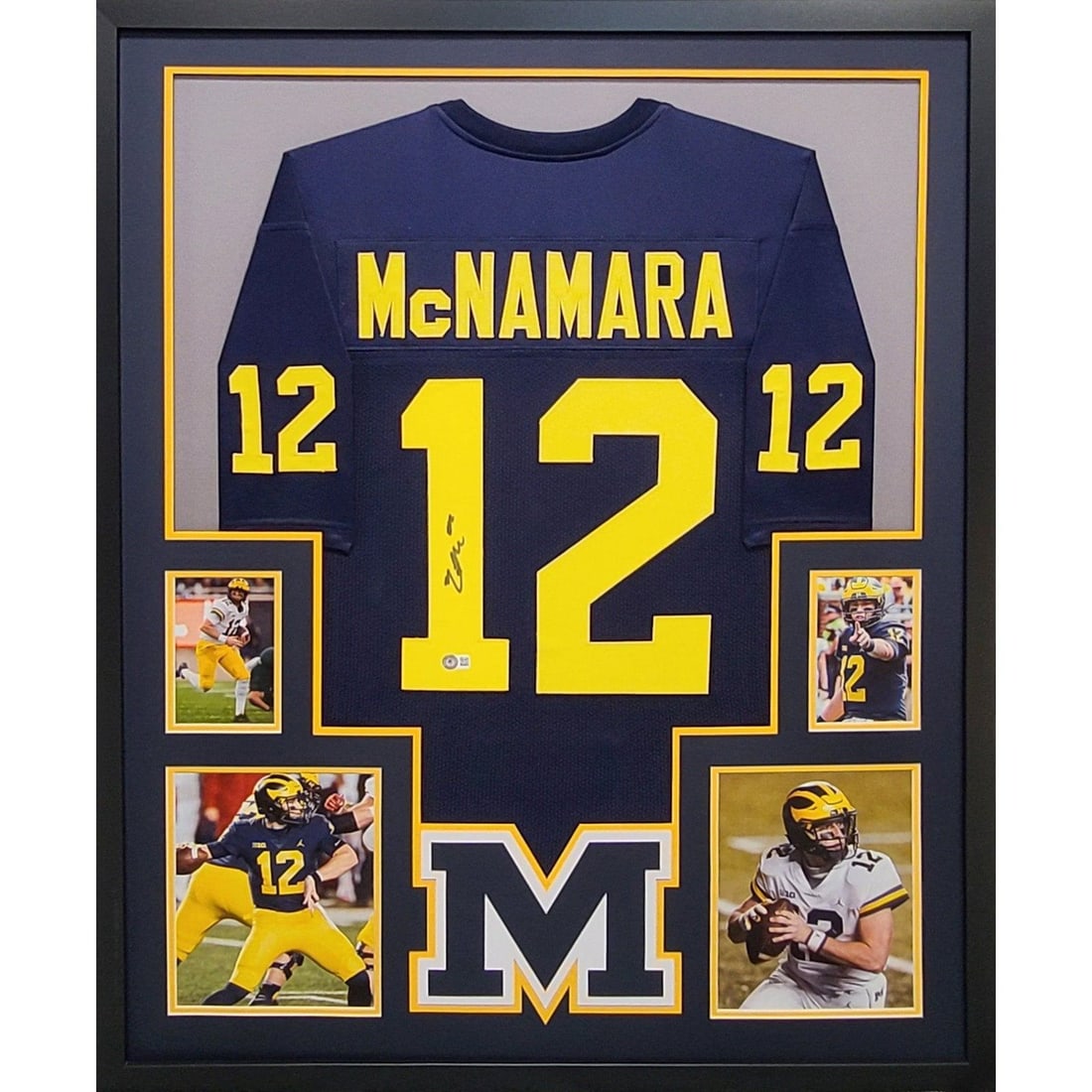 Cade McNamara Signed Jersey Framed Beckett Authenticated Michigan Wolverines: Cade McNamara Signed Jersey Framed Beckett Authenticated Michigan Wolverines This is a framed autographed jersey of Cade McNamara, the talented quarterback from the Michigan Wolverines. Authenticated