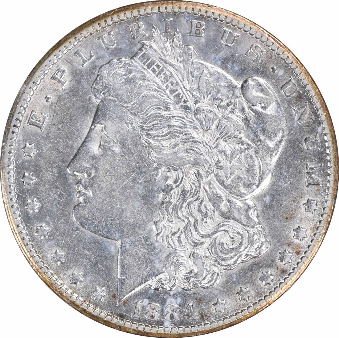 Carson City 1884 CC Morgan Dollar AU Grade Uncertified Silver Coin: Carson City 1884 CC Morgan Dollar AU Grade Uncertified Silver Coin This 1884-CC Morgan Silver Dollar is an un-certified coin struck at the Carson City Mint. Composed of 90% silver and 10% copper, it f