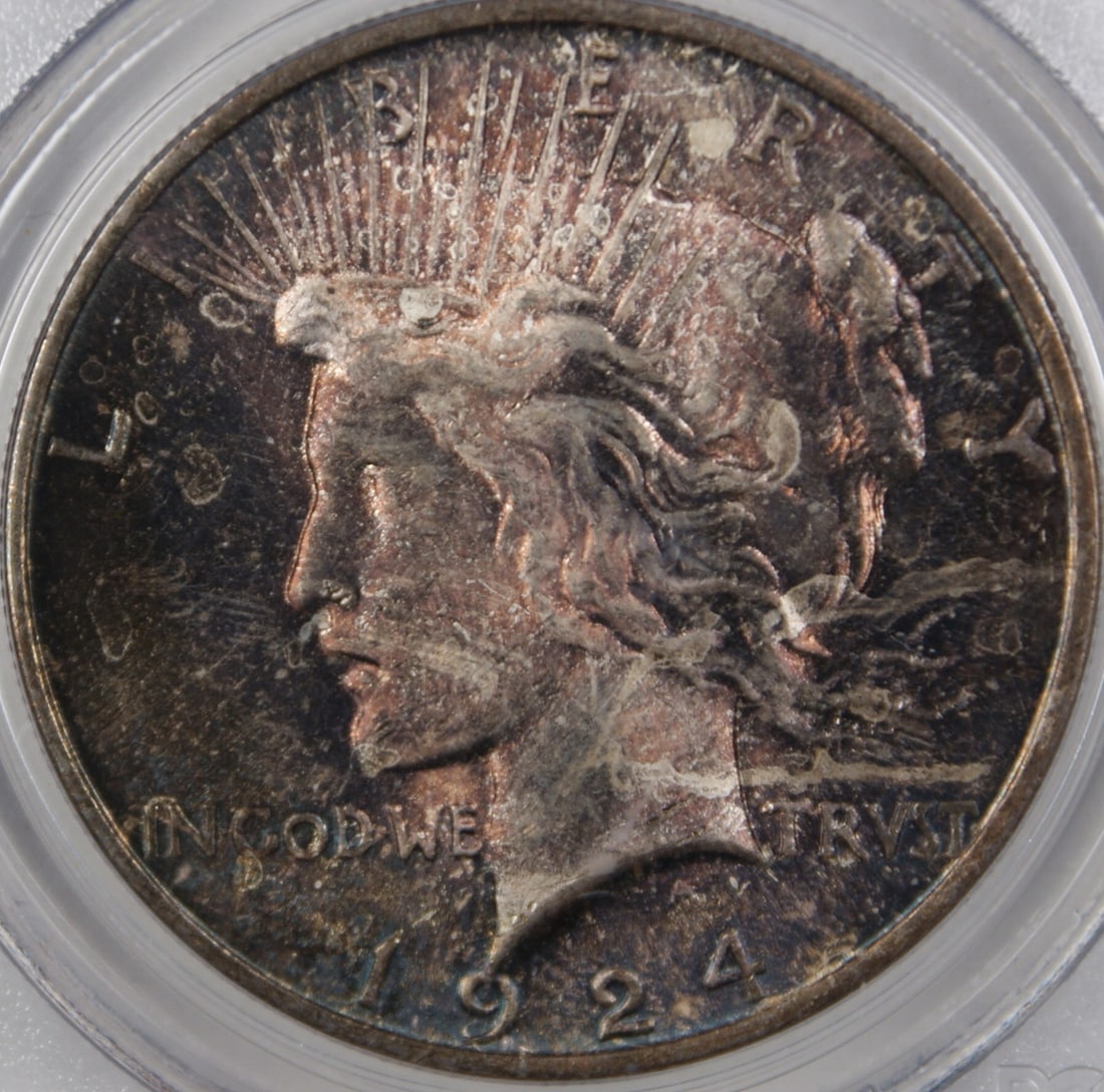PCGS MS-64 1924 Peace Dollar with Attractive Colorful Toning: PCGS MS-64 1924 Peace Dollar with Attractive Colorful Toning This is a 1924 Peace Silver Dollar graded MS-64 by PCGS, featuring beautiful natural toning. Struck at the Philadelphia Mint, this uncircul