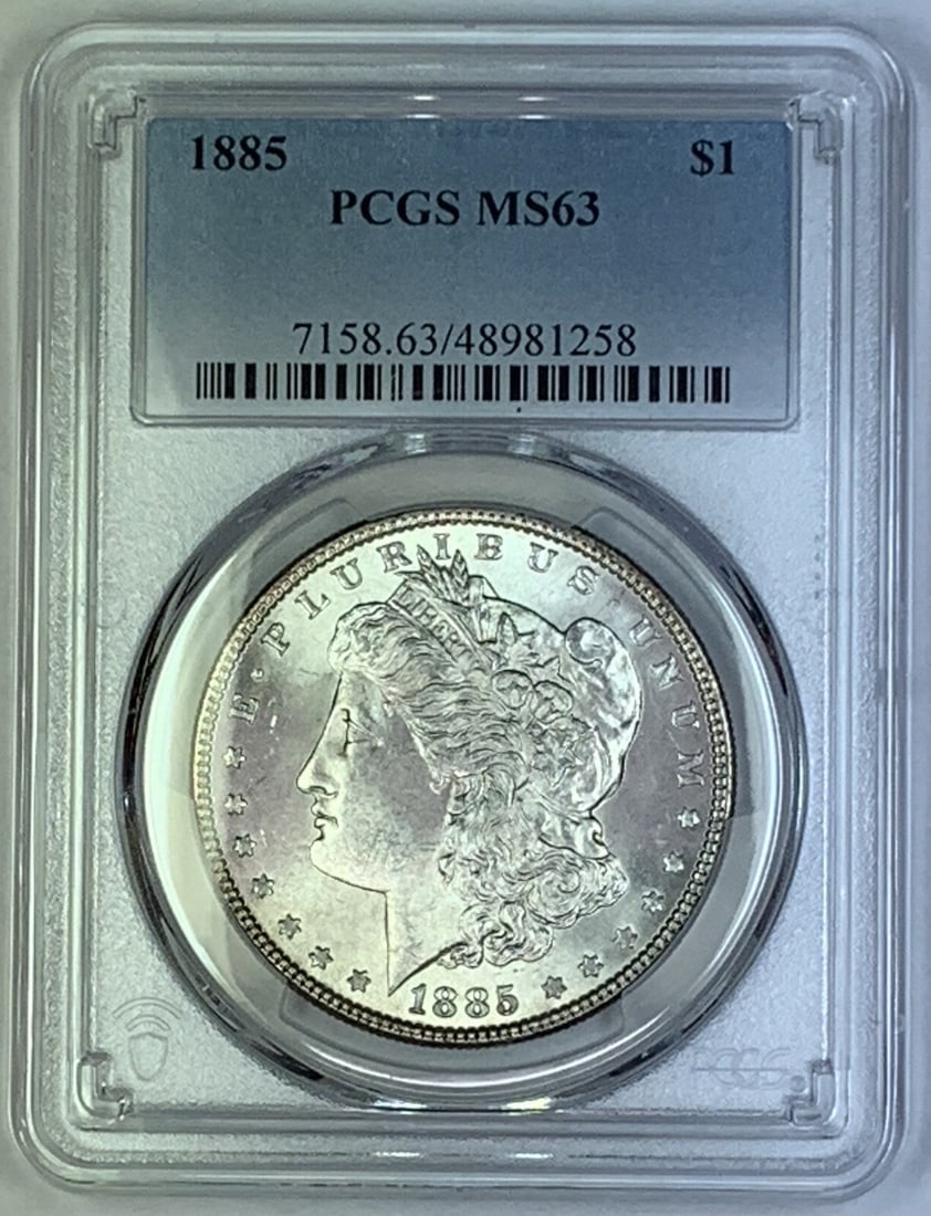 1885 Morgan Silver Dollar PCGS MS63 Certified Uncirculated Coin: 1885 Morgan Silver Dollar PCGS MS63 Certified Uncirculated Coin This 1885 Morgan Silver Dollar is an uncirculated coin graded MS 63 by PCGS. Minted in the United States, it features the classic Morgan