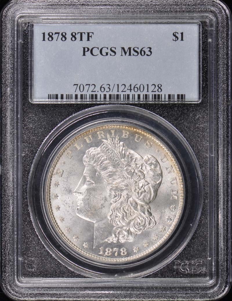 1878 Morgan Dollar PCGS MS63 Uncirculated Philadelphia Mint: 1878 Morgan Dollar PCGS MS63 Uncirculated Philadelphia Mint This 1878 Morgan Dollar is a stunning example of U.S. coinage, certified by PCGS with a grade of MS63, indicating it is in uncirculated cond
