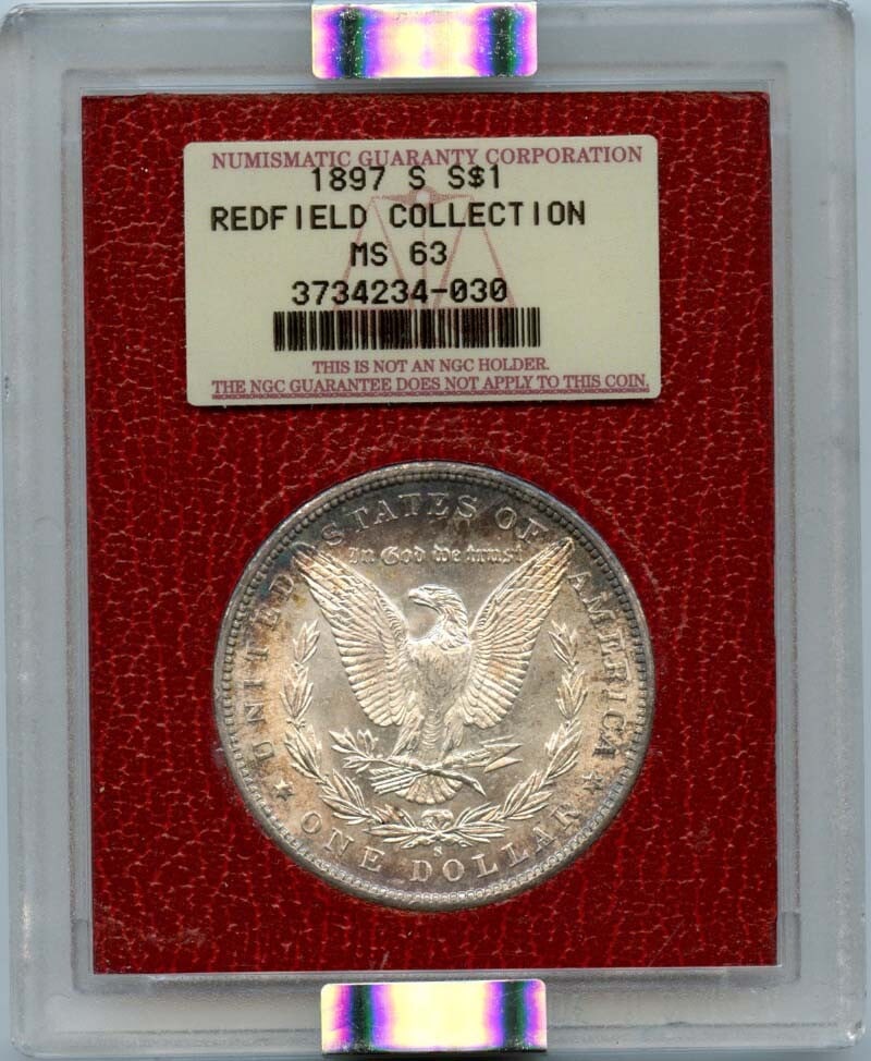 1897-S NGC MS63 Morgan Silver Dollar Redfield Collection: 1897-S NGC MS63 Morgan Silver Dollar Redfield Collection This 1897-S Morgan Silver Dollar is part of the esteemed Redfield Collection and has been certified by NGC with a grade of MS63. The coin was m