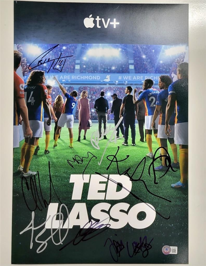 Ted Lasso 12x18 Signed Photo with 9 Cast Autographs Beckett Authenticated: Ted Lasso 12x18 Signed Photo with 9 Cast Autographs Beckett Authenticated This is an original 12x18 photo from the show Ted Lasso, featuring the autographs of nine cast members, including Jason Sudeik