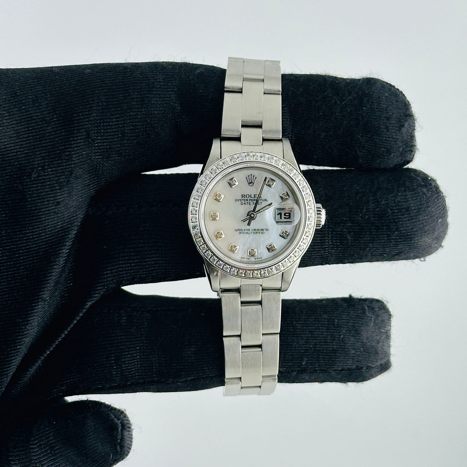 Ladies Datejust Ref 69190 White MOP Diamond Dial Oyster Bracelet AM: Ladies Datejust Ref 69190 White MOP Diamond Dial Oyster Bracelet AM This ladies Rolex Datejust features an after-market white mother of pearl dial set with diamond hour markers and a pave diamond beze