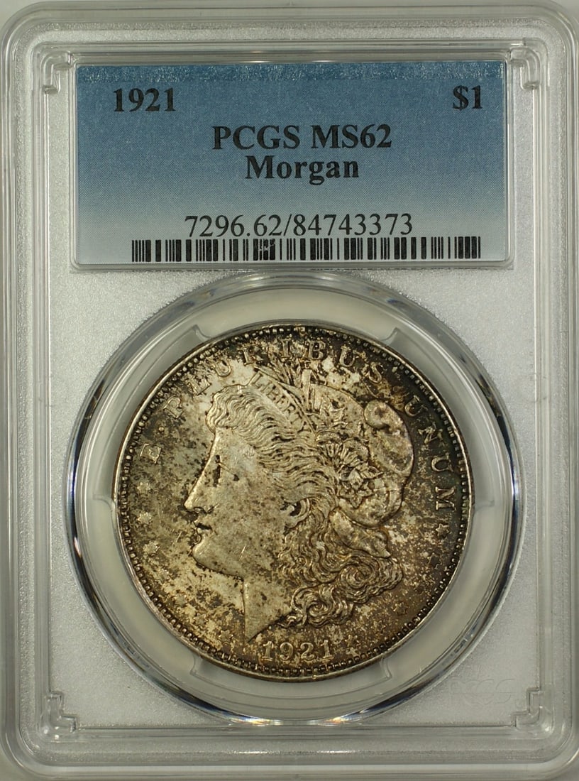 PCGS MS-62 Graded 1921 Toned Morgan Dollar Silver Coin from Philadelphia: PCGS MS-62 Graded 1921 Toned Morgan Dollar Silver Coin from Philadelphia This 1921 Morgan Silver Dollar is an uncirculated coin graded MS-62 by PCGS. Minted in Philadelphia, it features a silver compo
