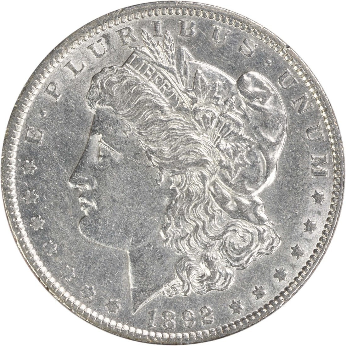 AU Grade 1892 Morgan Dollar 90 Percent Silver Uncertified Philadelphia Mint: AU Grade 1892 Morgan Dollar 90 Percent Silver Uncertified Philadelphia Mint This 1892 Morgan Silver Dollar was minted in Philadelphia and features a composition of 90% silver and 10% copper. Designed