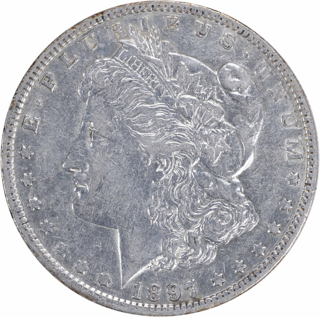 1897-O Morgan Silver Dollar AU Uncertified New Orleans Mint: 1897-O Morgan Silver Dollar AU Uncertified New Orleans Mint This 1897-O Morgan Silver Dollar is a remarkable piece of history, featuring a striking design by George T. Morgan. It is classified as AU (