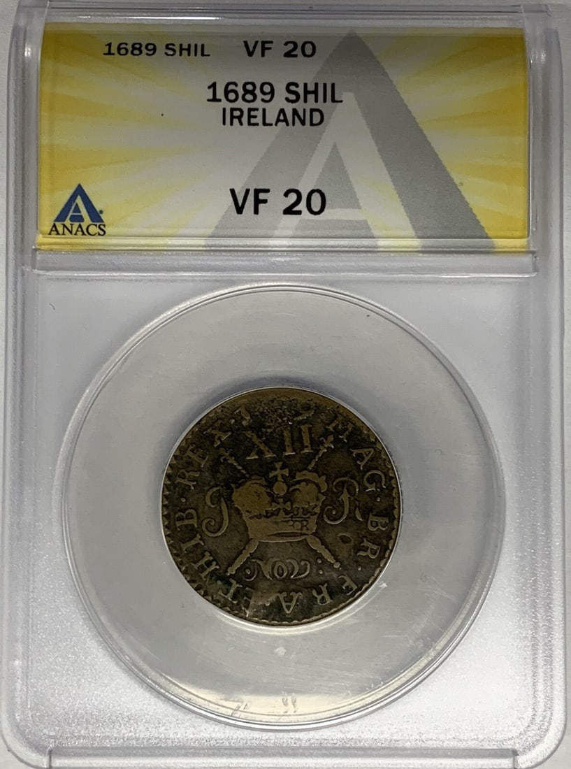 1689 Brass Ireland Shilling Certified by ANACS VF 20: 1689 Brass Ireland Shilling Certified by ANACS VF 20 This is a 1689 Ireland shilling coin graded VF 20 by ANACS. The coin is composed of brass and originates from Ireland, dated 1689. It is certified