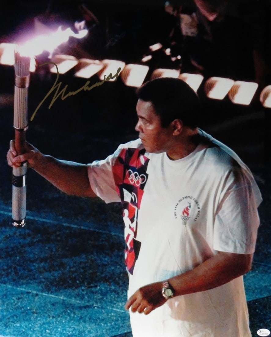Muhammad Ali Autographed 16X20 Photo Olympic Torch JSA Authenticated: Muhammad Ali Autographed 16X20 Photo Olympic Torch JSA Authenticated This striking 16X20 photo captures the legendary Muhammad Ali lighting the Olympic torch during the 1996 Summer Olympics. Authentic