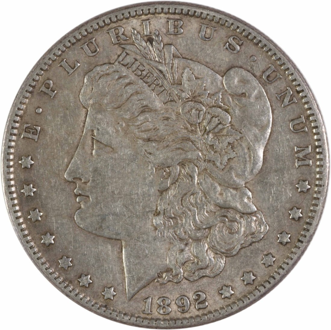 1892-O Morgan Silver Dollar EF Uncertified 90% Silver George T Morgan: 1892-O Morgan Silver Dollar EF Uncertified 90% Silver George T Morgan Introducing the 1892-O Morgan Silver Dollar, a captivating piece of numismatic history. This coin, designed by George T. Morgan, f