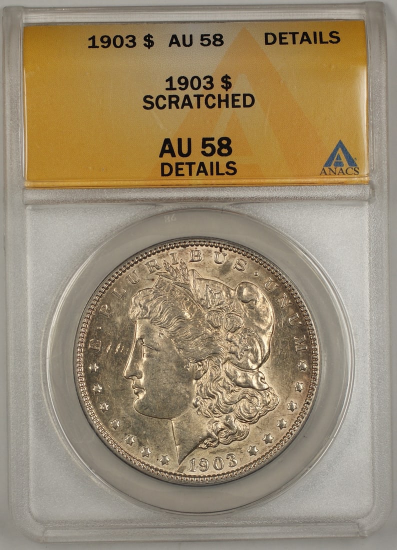 ANACS AU-58 1903 Morgan Silver Dollar with Scratches: ANACS AU-58 1903 Morgan Silver Dollar with Scratches This 1903 Morgan Silver Dollar is a $1 coin from the United States, certified by ANACS with a grade of AU-58 Details. The coin is composed of silve