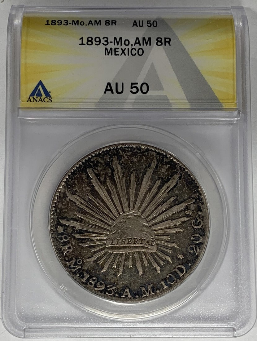 ANACS AU 50 Certified 1893-Mo AM Mexico 8 Reales Silver Coin: ANACS AU 50 Certified 1893-Mo AM Mexico 8 Reales Silver Coin This is an 1893-Mo,AM Mexico 8 Reales silver coin from the Colonial period, certified by ANACS with a grade of AU 50. The coin is pre-owned