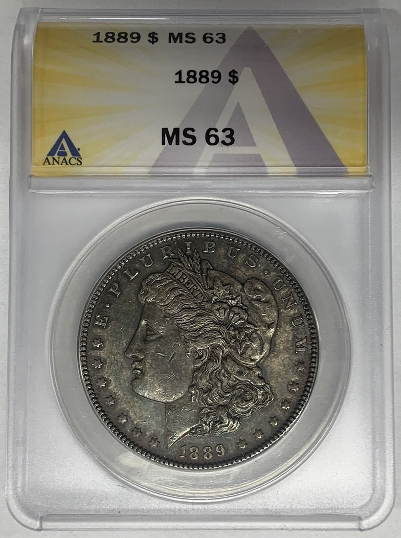 Toned 1889 Silver Morgan Dollar ANACS MS 63 Certified Coin: Toned 1889 Silver Morgan Dollar ANACS MS 63 Certified Coin This is an 1889 Morgan Silver Dollar coin from the United States, featuring attractive toning. The coin is uncirculated and has been graded M
