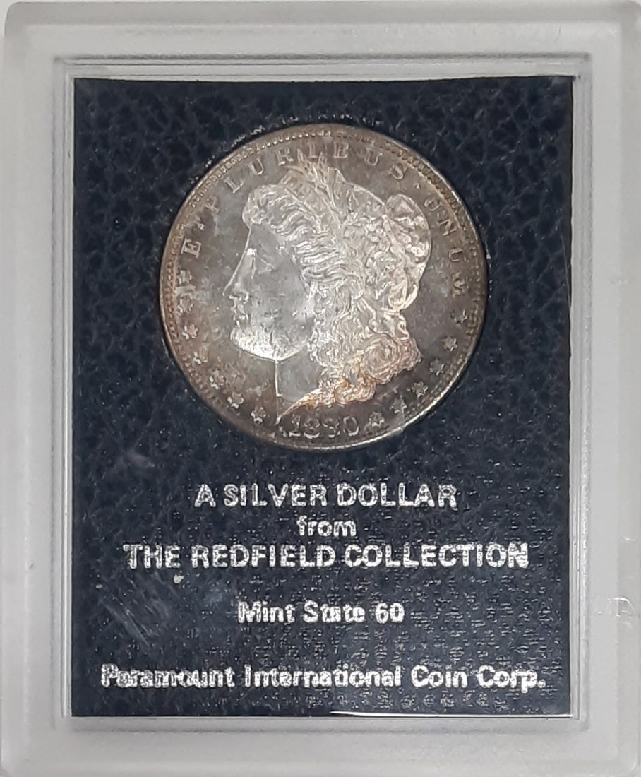 Uncirculated 1880-S Morgan Silver Dollar from Redfield Hoard with Toning: Uncirculated 1880-S Morgan Silver Dollar from Redfield Hoard with Toning This is an uncirculated 1880-S Morgan Silver Dollar from the Redfield Collection, housed in a Redfield Hoard holder. The coin f