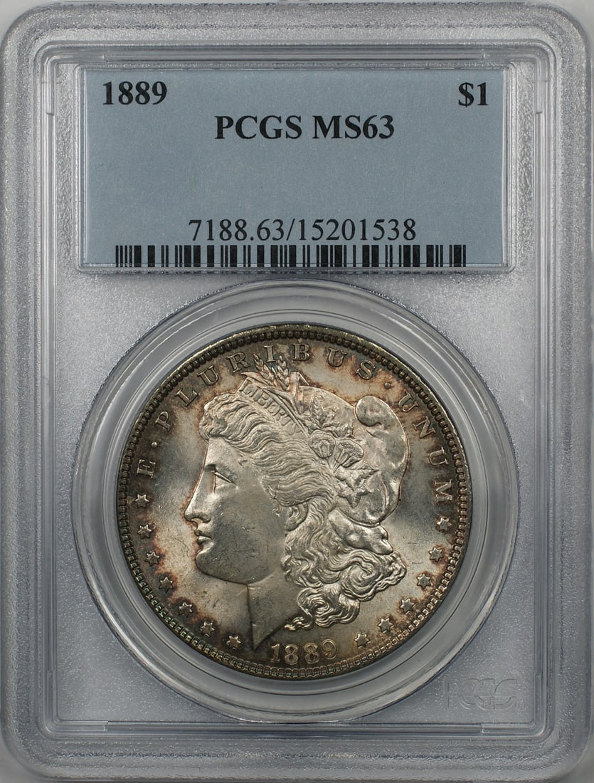 PCGS MS63 1889 Morgan Dollar Silver Coin With Toning: PCGS MS63 1889 Morgan Dollar Silver Coin With Toning This is an 1889 Morgan Silver Dollar $1 coin, certified by PCGS with a grade of MS 63. The coin is uncirculated and has a toned appearance. It was