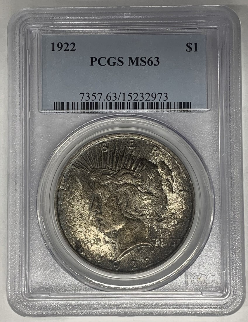 PCGS MS 63 1923 Toned Peace Silver Dollar United States $1 Coin: PCGS MS 63 1923 Toned Peace Silver Dollar United States $1 Coin This is a 1923 Peace Silver Dollar coin from the United States, graded MS 63 by PCGS. The coin is uncirculated and features attractive t