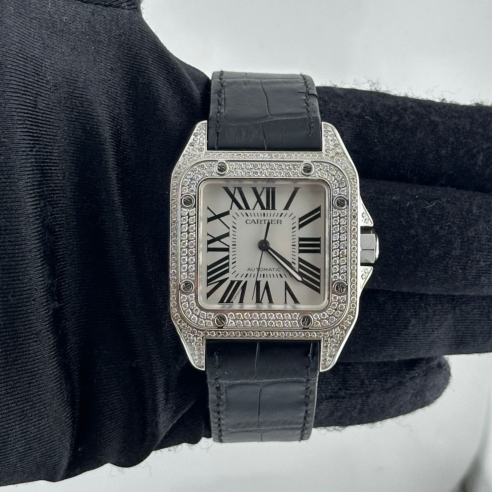 Santos Ref 2656 Silver Roman Dial Watch with Aftermarket Leather Strap: Santos Ref 2656 Silver Roman Dial Watch with Aftermarket Leather Strap This Cartier Santos men's watch features a silver Roman numeral dial and a diamond bezel. It is paired with an aftermarket leathe