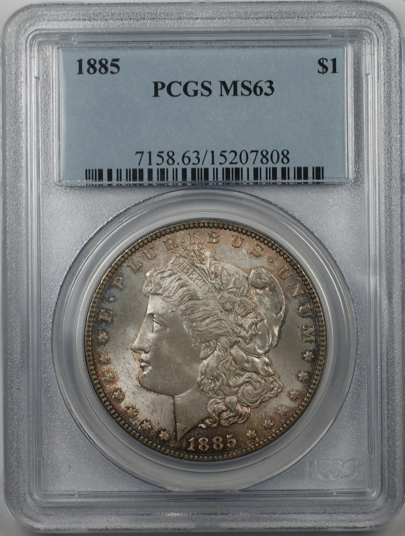 PCGS MS 63 1885 Philadelphia Morgan Dollar Silver Coin Toned: PCGS MS 63 1885 Philadelphia Morgan Dollar Silver Coin Toned This 1885 Morgan Silver Dollar is an uncirculated coin graded MS 63 by PCGS. It was minted in Philadelphia and features a toned finish. The