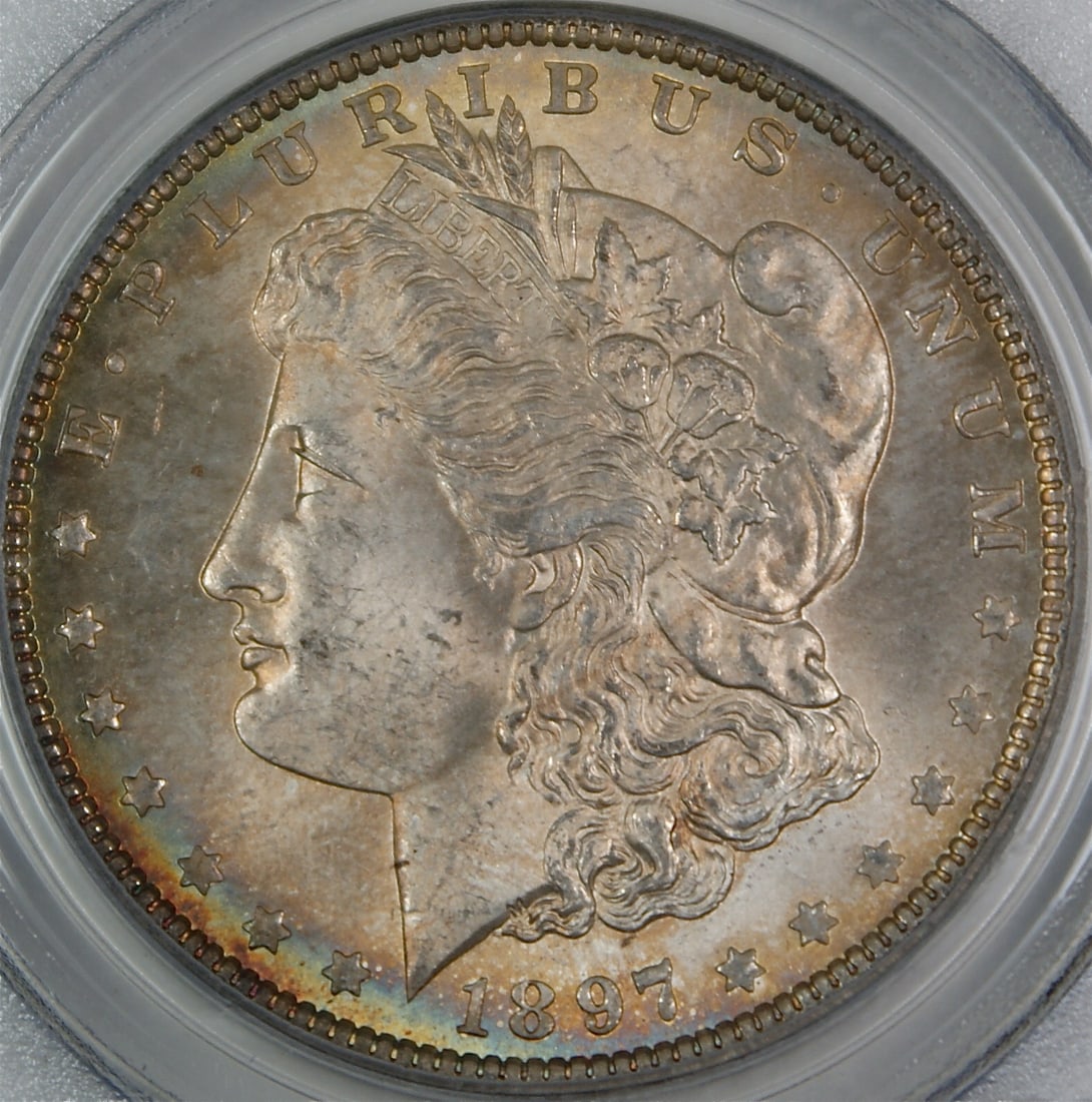 PCGS MS-63 1897 Philadelphia Morgan Dollar Toned Silver Coin: PCGS MS-63 1897 Philadelphia Morgan Dollar Toned Silver Coin This 1897 Morgan Silver Dollar is graded MS-63 by PCGS and features attractive toning. Struck in Philadelphia, this uncirculated coin is a