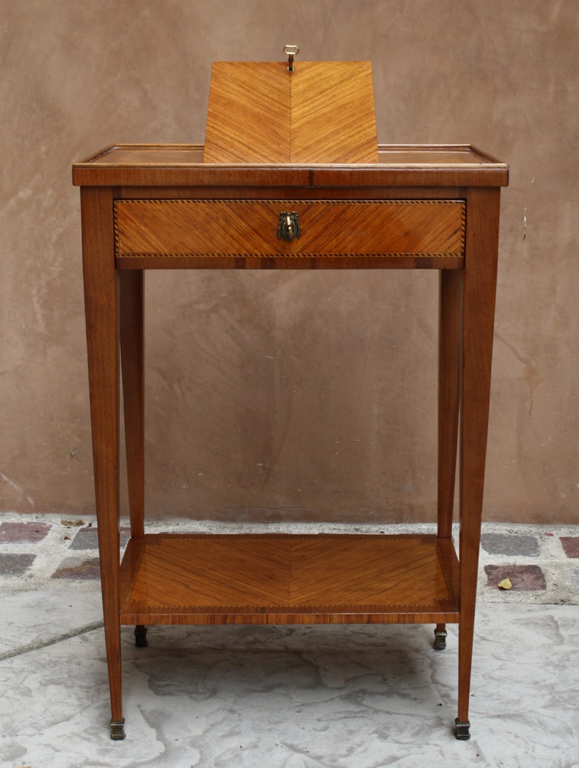 19th Century Louis XVI Fruit Wood Reading Table by V. Gillino: 19th Century Louis XVI Fruit Wood Reading Table by V. Gillino This exquisite 19th-century Louis XVI reading table, crafted from fruit wood, showcases exceptional detail and craftsmanship. Designed for