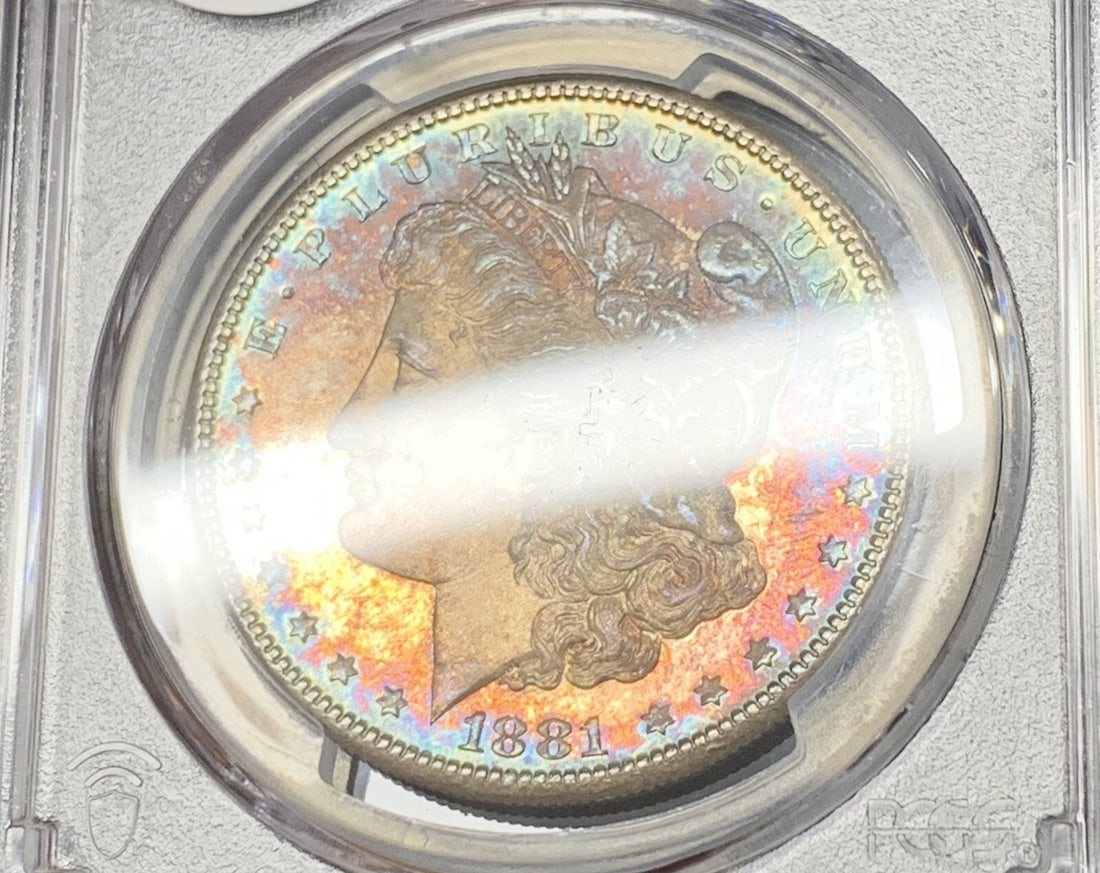 PCGS MS 65 1881-S Morgan Dollar Silver Coin With Toning: PCGS MS 65 1881-S Morgan Dollar Silver Coin With Toning This is an 1881-S Morgan Silver Dollar featuring attractive toning. The coin is graded MS 65 by PCGS and is composed of silver. It has a denomin
