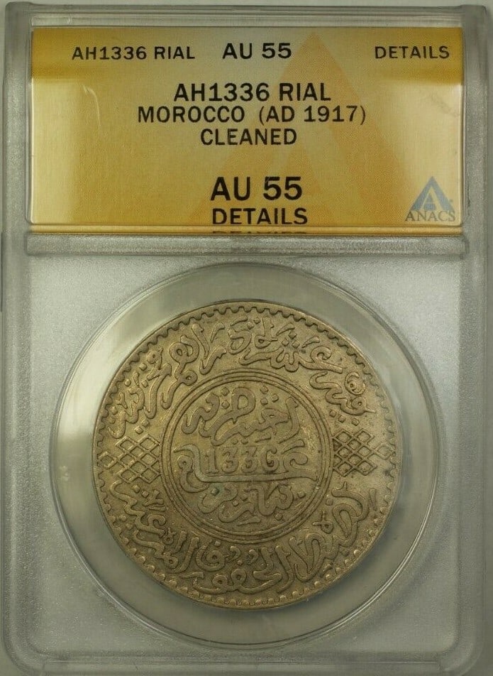 Morocco 1917 1 Rial ANACS AU 55 Certified Cleaned Coin: Morocco 1917 1 Rial ANACS AU 55 Certified Cleaned Coin This is a 1 Rial coin from Morocco dated AH1336 (AD 1917), certified by ANACS with a grade of AU 55 and noted as having cleaned details. The coin