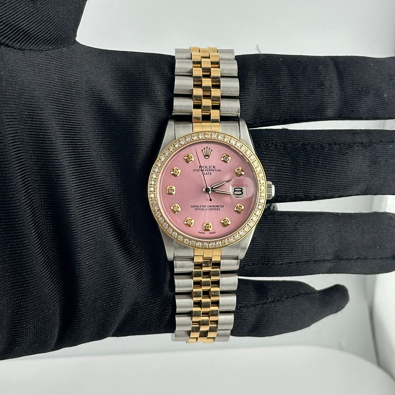 AM Pink Diamond Dial Datejust Ref 6694 with Aftermarket Jubilee Bracelet: AM Pink Diamond Dial Datejust Ref 6694 with Aftermarket Jubilee Bracelet This Rolex Datejust watch features an aftermarket pink diamond dial and an aftermarket Jubilee bracelet. It is designed for men
