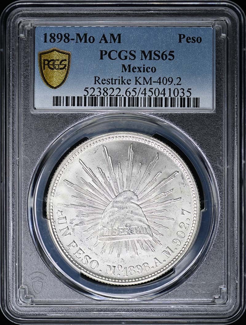 1898 Mo AM Peso Silver Coin PCGS MS65 Uncirculated: 1898 Mo AM Peso Silver Coin PCGS MS65 Uncirculated This stunning 1898-Mo AM Peso Restrike is an uncirculated silver coin certified by PCGS with a remarkable grade of MS65. It showcases pristine detail