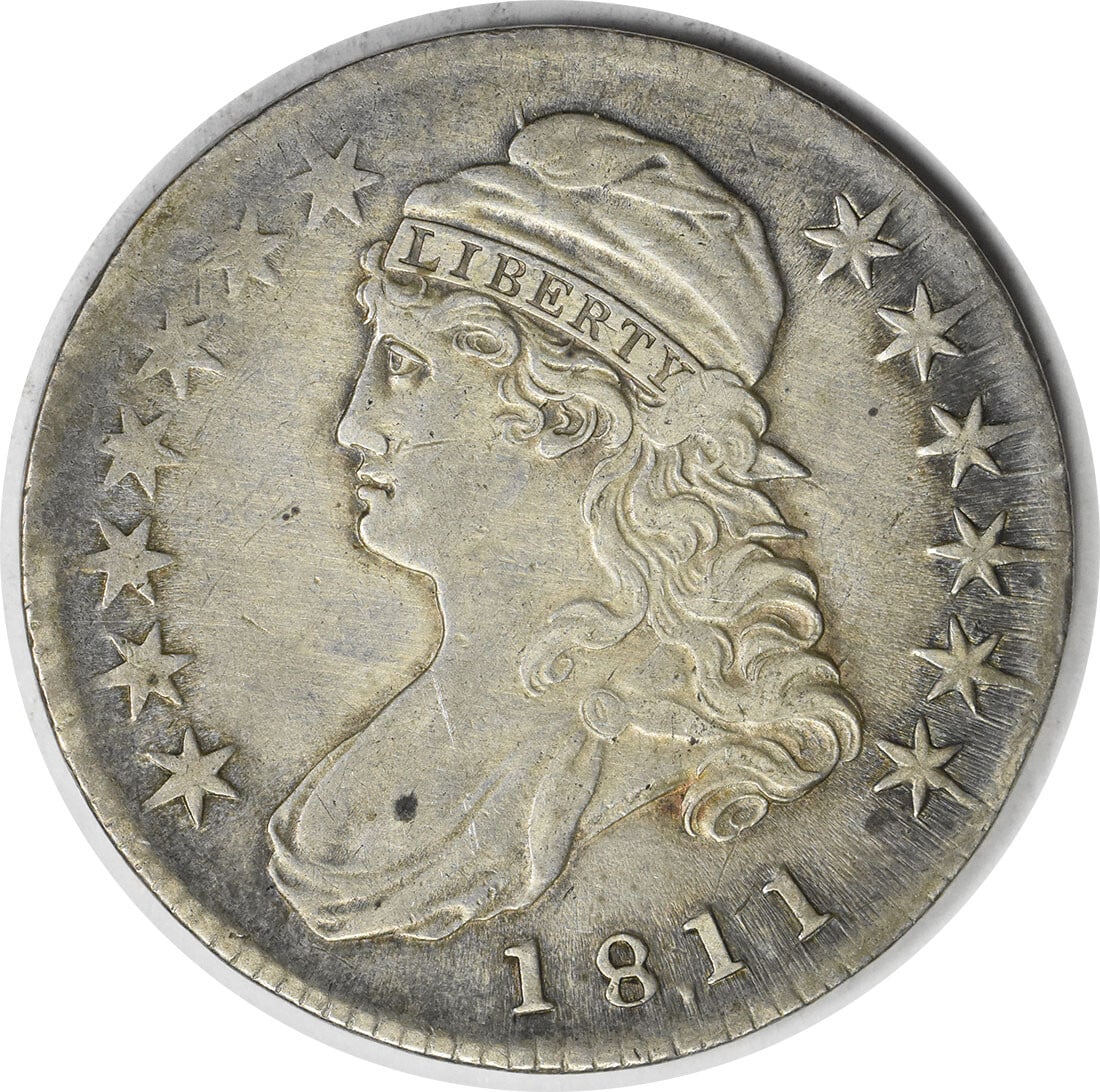 1811 Bust Half Dollar 50C by John Reich Uncertified Silver Coin: 1811 Bust Half Dollar 50C by John Reich Uncertified Silver Coin This 1811 Bust Half Dollar is an exquisite piece of American history, featuring a design by John Reich. The coin, minted in Philadelphia