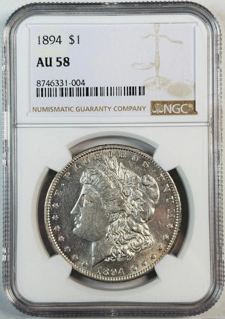 NGC AU 58 1894 Silver Morgan Dollar Certified Coin: NGC AU 58 1894 Silver Morgan Dollar Certified Coin This is an 1894 Morgan Silver Dollar certified by NGC with a grade of AU 58. The coin is composed of silver, has a denomination of one dollar, and or