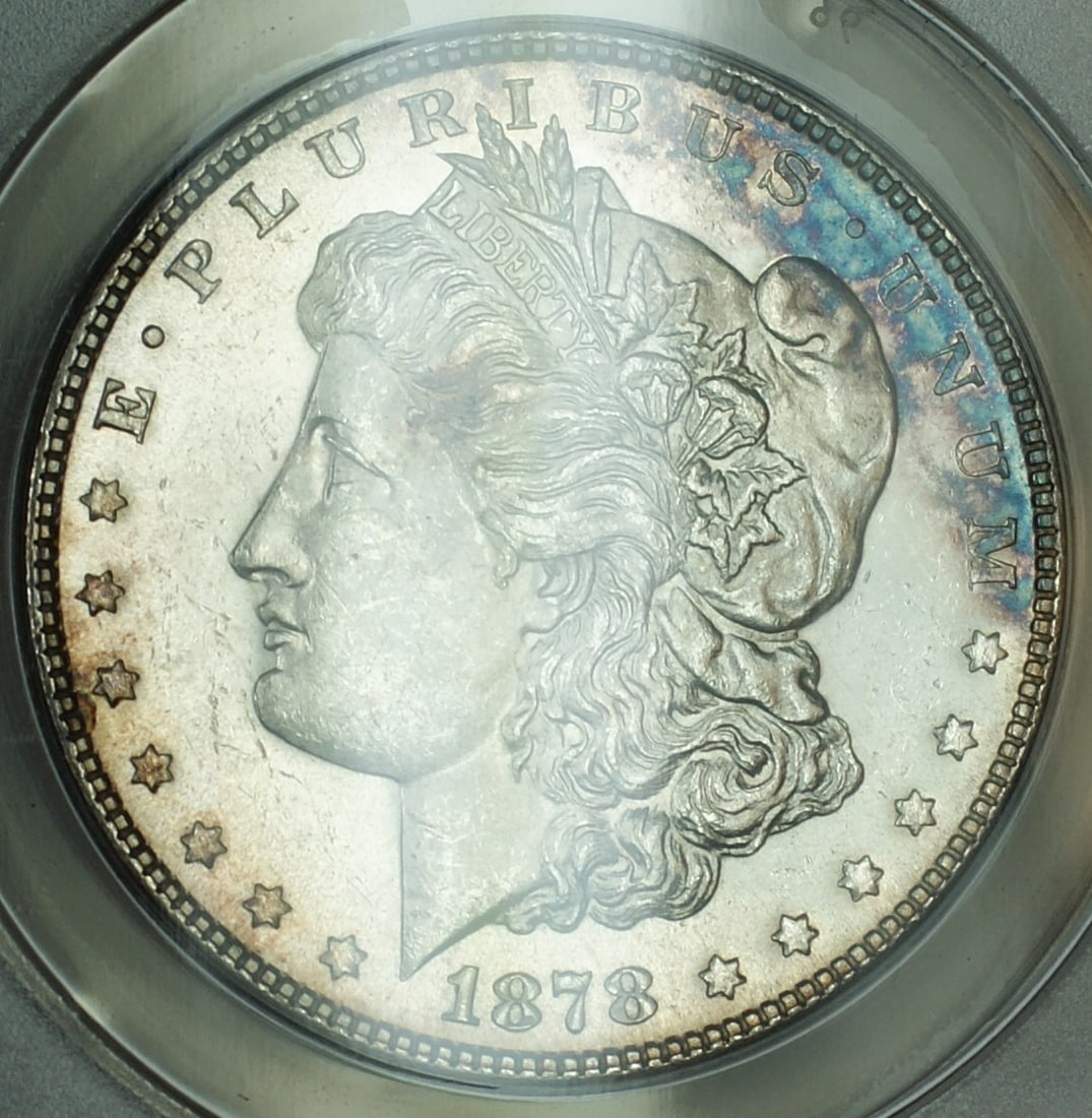1878 Morgan Dollar 7 Tail Feathers ANACS MS 62 Philadelphia Silver Coin: 1878 Morgan Dollar 7 Tail Feathers ANACS MS 62 Philadelphia Silver Coin This 1878 Morgan Silver Dollar features the 7 Tail Feathers variety and was minted in Philadelphia. Certified by ANACS with a gr