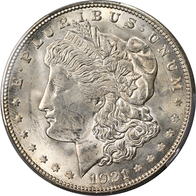 1921-D Morgan Silver Dollar PCGS MS63 Blast White Uncirculated Coin: 1921-D Morgan Silver Dollar PCGS MS63 Blast White Uncirculated Coin This stunning 1921-D Morgan Silver Dollar showcases exceptional eye appeal with its brilliant blast white finish and impressive lust