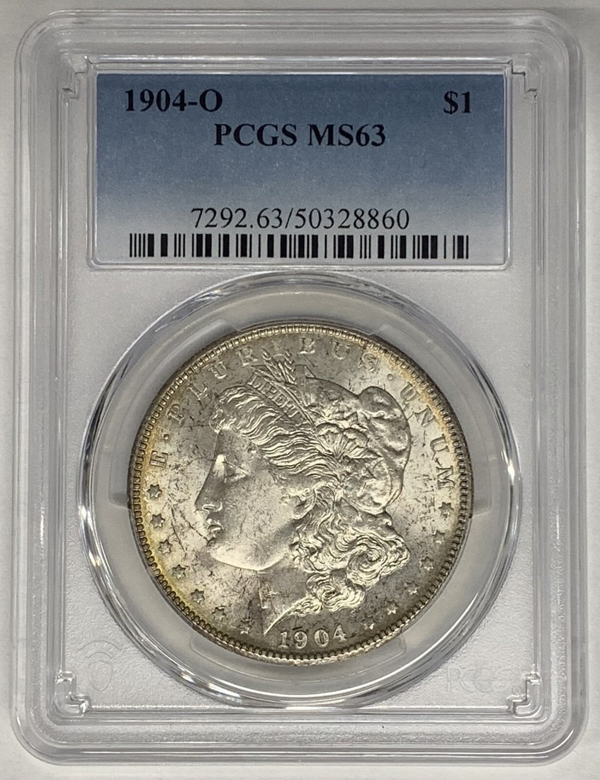 1904-O Morgan Dollar Silver $1 Coin PCGS MS 63 Certified: 1904-O Morgan Dollar Silver $1 Coin PCGS MS 63 Certified This is a 1904-O Morgan Silver Dollar coin graded MS 63 by PCGS. The coin is uncirculated and composed of silver. It originates from the United