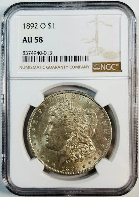 1892 New Orleans Morgan Silver Dollar AU 58 Certified by NGC: 1892 New Orleans Morgan Silver Dollar AU 58 Certified by NGC This 1892 O Morgan Silver Dollar is certified by NGC with an AU-58 grade. Struck at the New Orleans Mint, the coin is composed of silver an