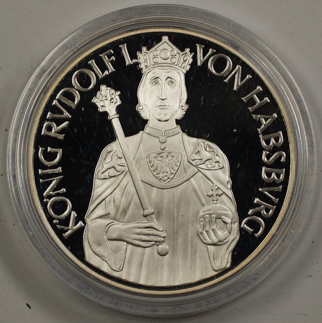 Austria 1991 Silver 100 Schilling Commemorative Coin King Rudolf I: Austria 1991 Silver 100 Schilling Commemorative Coin King Rudolf I This is a 1991 Austria 100 Schilling silver commemorative coin honoring King Rudolf I Von Hapsberg. The obverse features a portrait o