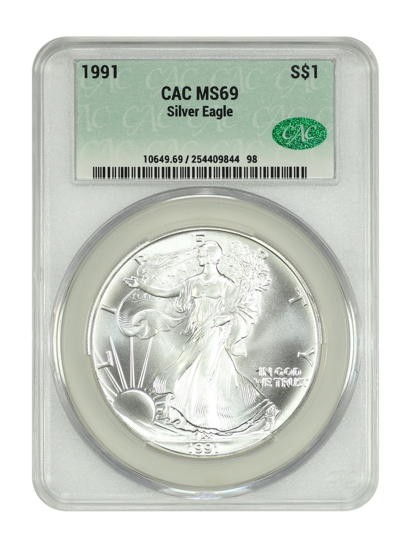 1991 $1 American Silver Eagle CACG MS69 Graded Coin: 1991 $1 American Silver Eagle CACG MS69 Graded Coin This 1991 $1 Silver Eagle bullion coin contains one ounce of pure silver. Graded MS69 by CAC Grading, it is in near-perfect condition and uncirculat