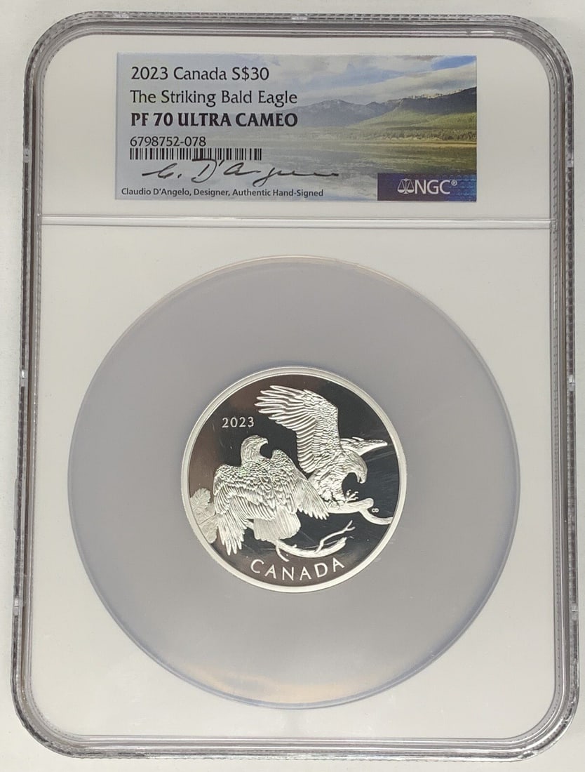 2023 Silver $30 Bald Eagle Coin NGC PR 70 Signed by Claudio D'Angelo: 2023 Silver $30 Bald Eagle Coin NGC PR 70 Signed by Claudio D'Angelo This is a 2023 Canada $30 silver commemorative coin titled 'The Striking Bald Eagle.' The coin is graded PR 70 UCAM by NGC and feat