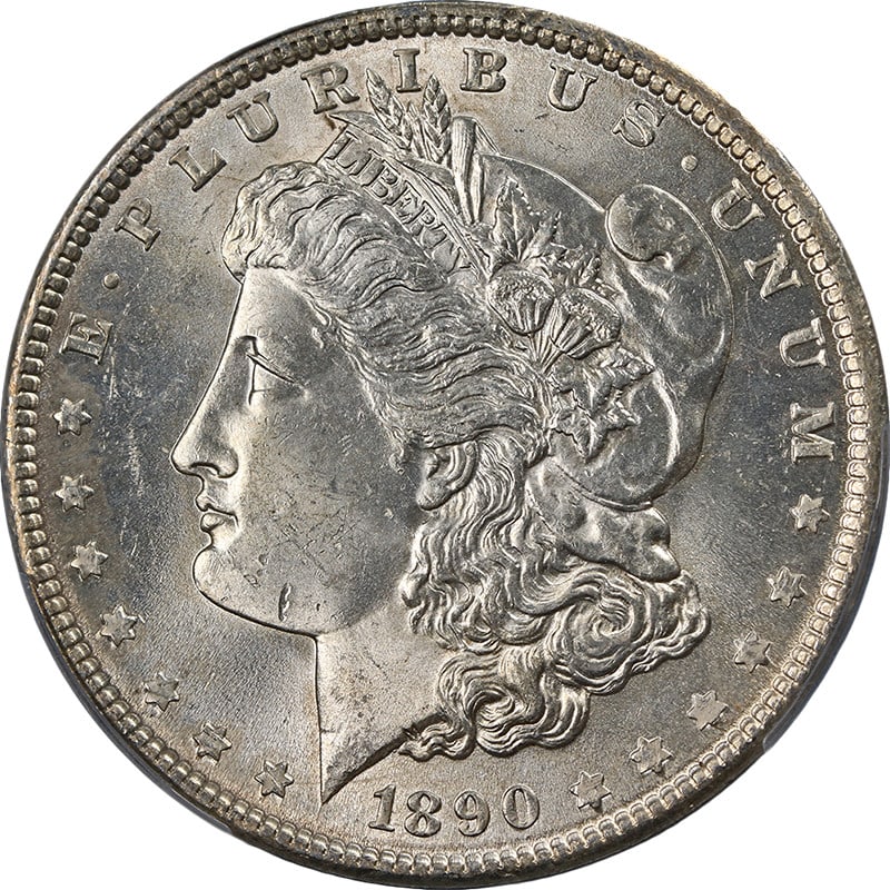 1890-P Morgan Silver Dollar PCGS MS63 Uncirculated Silver Coin: 1890-P Morgan Silver Dollar PCGS MS63 Uncirculated Silver Coin This 1890-P Morgan Silver Dollar is graded PCGS MS63, showcasing uncirculated condition with appealing luster and strike. The coin featur