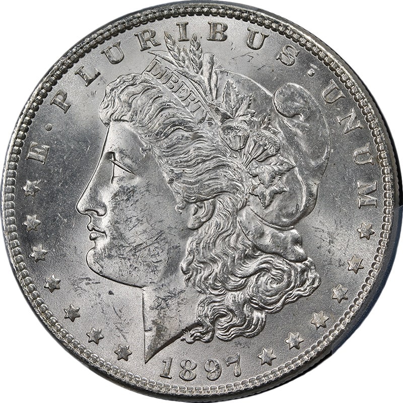 1897-P Morgan Silver Dollar PCGS MS63 Blast White Uncirculated Silver Coin: 1897-P Morgan Silver Dollar PCGS MS63 Blast White Uncirculated Silver Coin This stunning 1897-P Morgan Silver Dollar boasts exceptional eye appeal, featuring a brilliant luster and strong strike. Grad