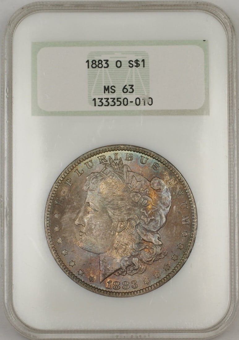 NGC MS 63 1883-O Silver Morgan Dollar with Attractive Obverse Toning: NGC MS 63 1883-O Silver Morgan Dollar with Attractive Obverse Toning This 1883-O Morgan Silver Dollar is certified by NGC with a grade of MS-63, indicating it is uncirculated and in excellent conditio