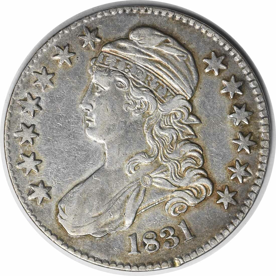 1831 Bust Half Dollar Choice EF John Reich Design Uncertified: 1831 Bust Half Dollar Choice EF John Reich Design Uncertified This 1831 Bust Half Dollar is a captivating piece from the Philadelphia mint, showcasing the artistry of designer John Reich. The coin, ma