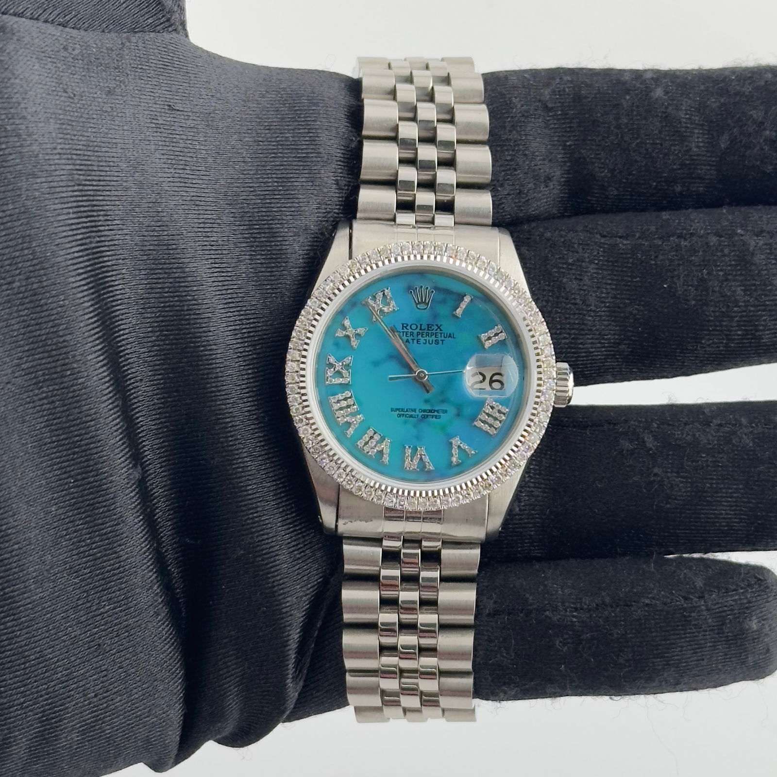 Rolex Datejust 1601 Mens Aftermarket Turquoise Roman Dial Diamond Bezel Jubilee: Rolex Datejust 1601 Mens Aftermarket Turquoise Roman Dial Diamond Bezel Jubilee This is a men's Rolex Datejust watch featuring an aftermarket turquoise Roman numeral dial and a diamond bezel. The watc