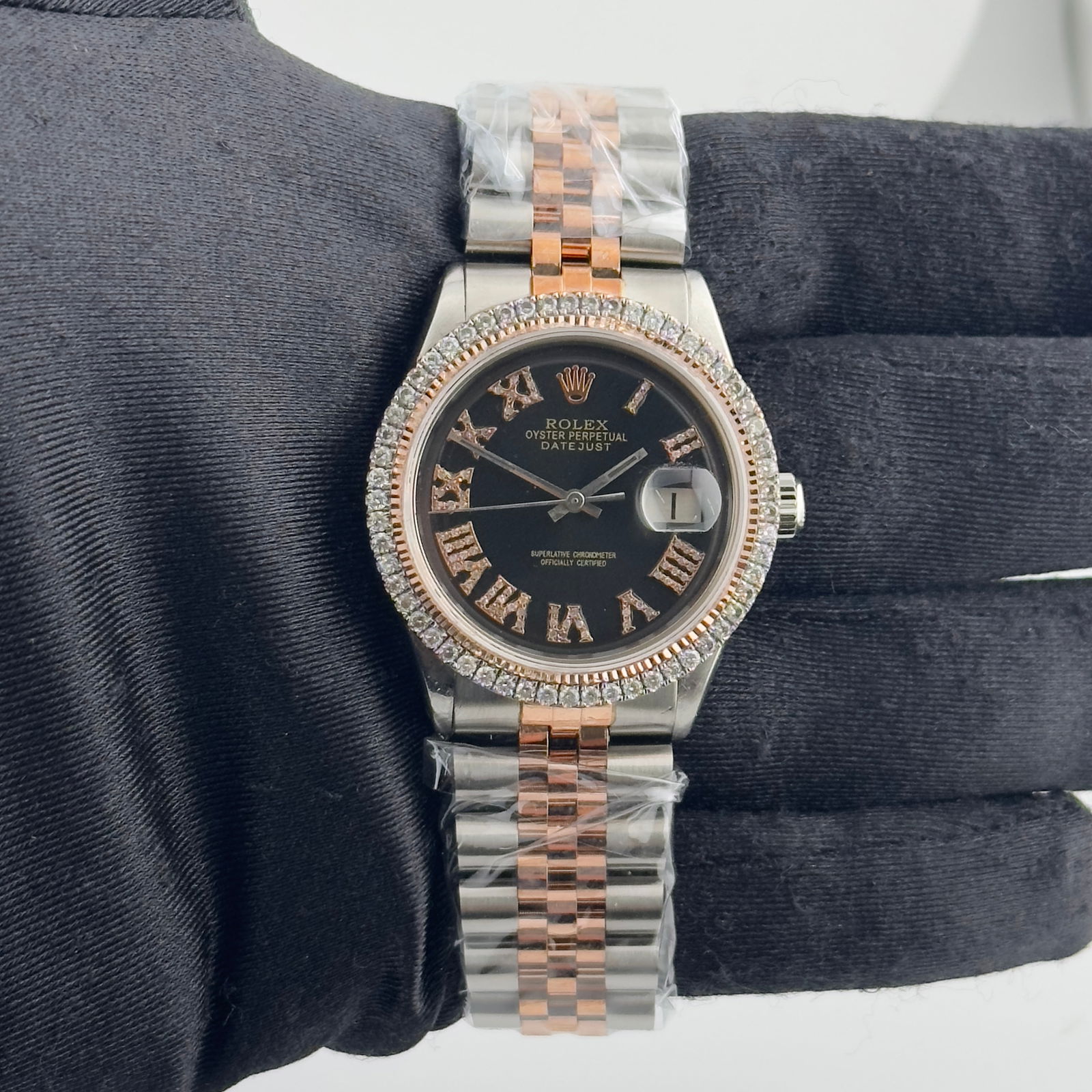 1601 Datejust Wristwatch with Aftermarket Black Roman Dial and Jubilee Bracelet: 1601 Datejust Wristwatch with Aftermarket Black Roman Dial and Jubilee Bracelet This is a men's Rolex Datejust watch, reference number 1601, featuring an aftermarket black Roman numeral dial and an af