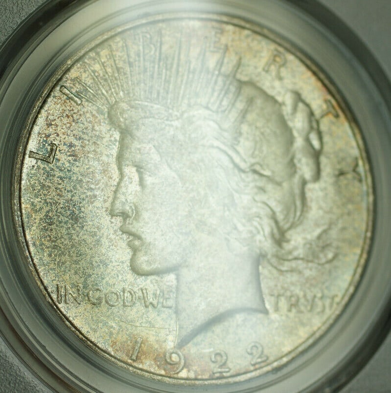 PCGS MS64 1922-D Peace Dollar Silver $1 Coin with Toning: PCGS MS64 1922-D Peace Dollar Silver $1 Coin with Toning This is a 1922-D Peace Silver Dollar $1 coin, certified by PCGS with a grade of MS-64. The coin is uncirculated and features a toned appearance