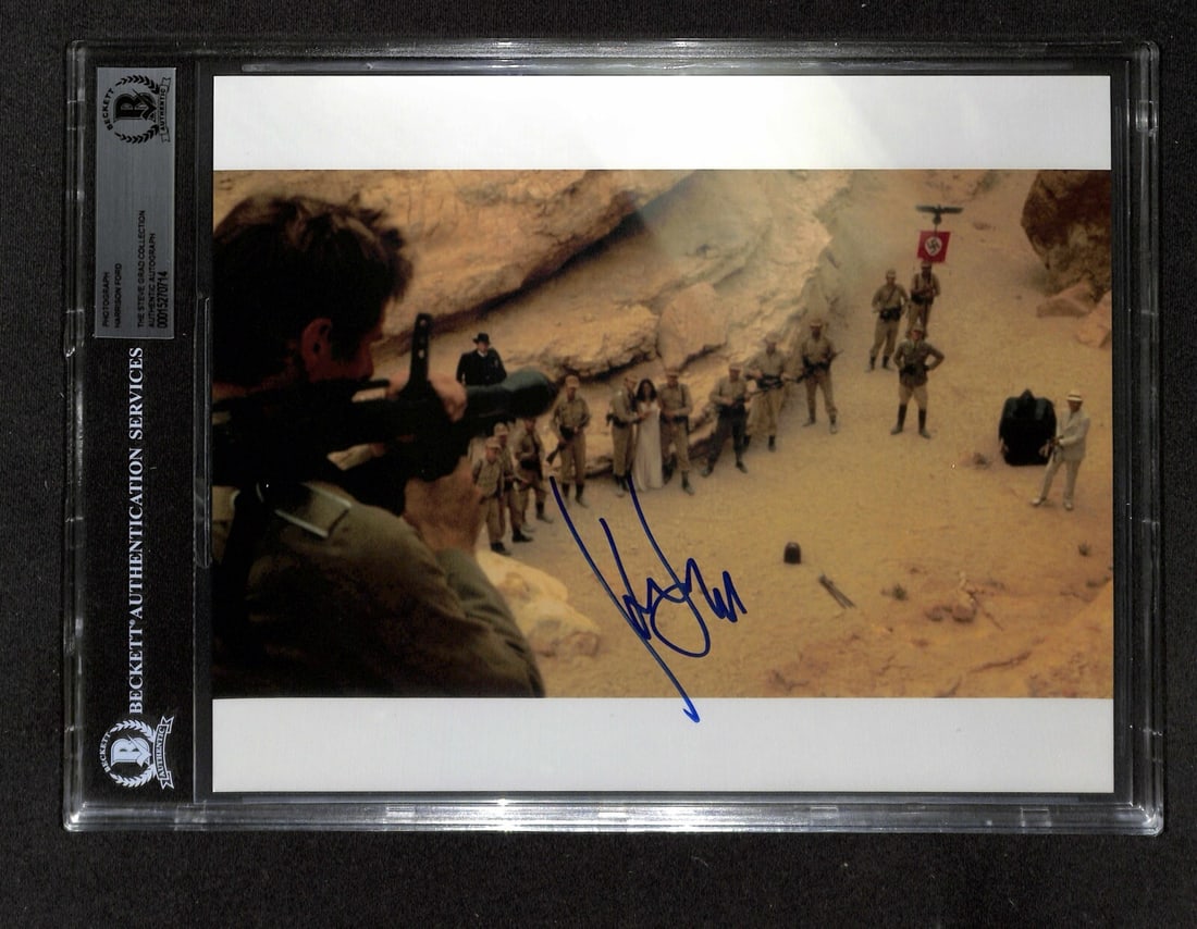 Harrison Ford Signed 8x10 Indiana Jones Photo Beckett Authenticated: Harrison Ford Signed 8x10 Indiana Jones Photo Beckett Authenticated This is an original signed 8x10 color photograph of Harrison Ford as Indiana Jones in Raiders of the Lost Ark. The photograph featur