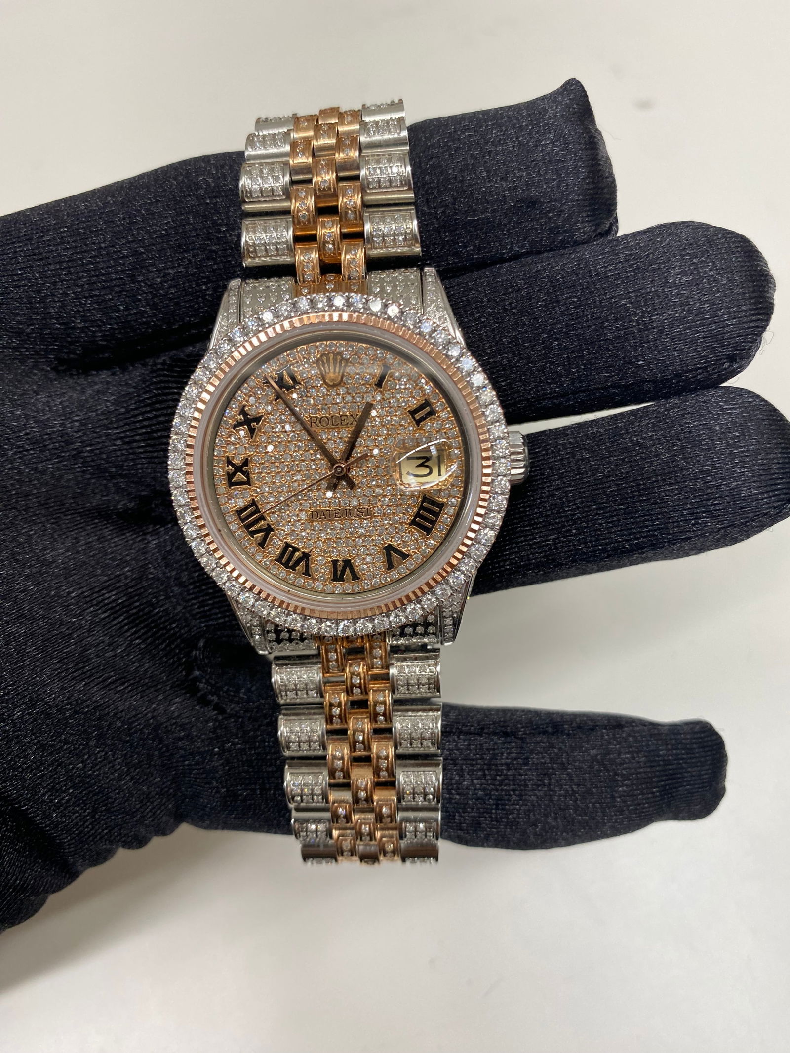 Rolex Datejust 1601 Mens Watch Aftermarket Jubilee Iced Out Roman Dial: Rolex Datejust 1601 Mens Watch Aftermarket Jubilee Iced Out Roman Dial This Rolex Datejust features an iced out Roman numeral dial, a prong rose plated bezel, and an aftermarket Jubilee bracelet fully