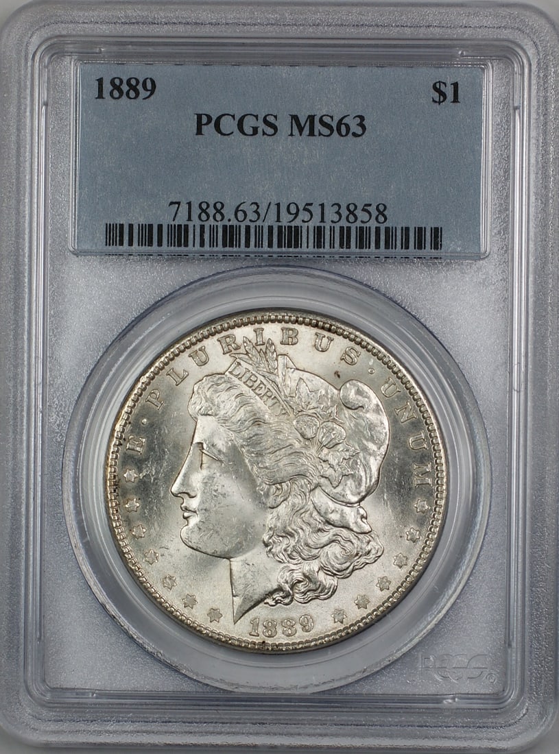 PCGS MS-63 1889 Silver Morgan Dollar Coin Philadelphia Mint: PCGS MS-63 1889 Silver Morgan Dollar Coin Philadelphia Mint This is an 1889 Morgan Silver Dollar graded MS-63 by PCGS. Struck in Philadelphia, this uncirculated coin is composed of silver and certifie