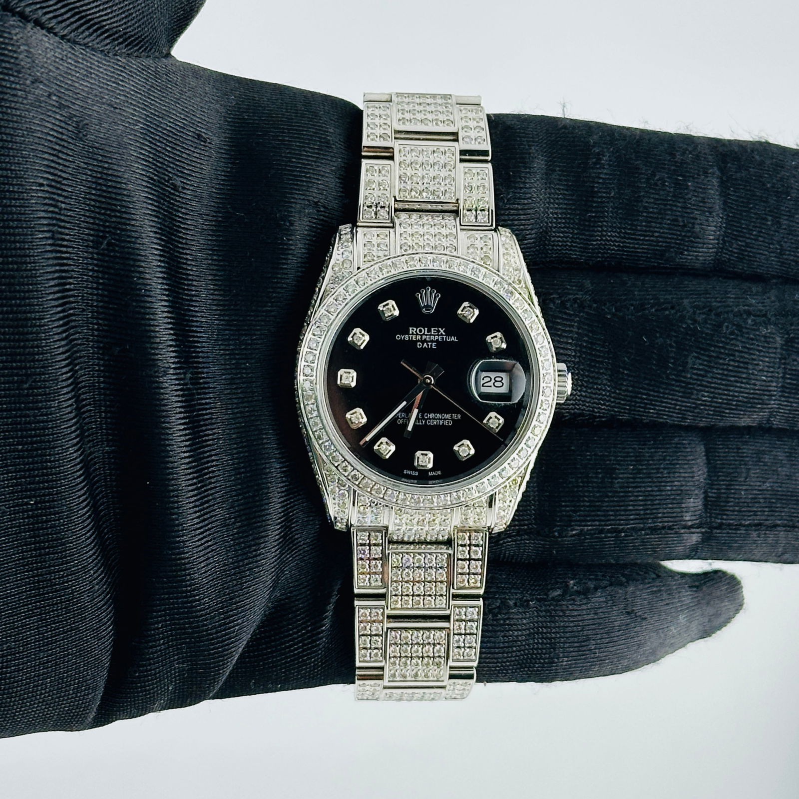 Rolex 115200 Aftermarket Black Diamond Dial Iced Out Oyster Bracelet Watch: Rolex 115200 Aftermarket Black Diamond Dial Iced Out Oyster Bracelet Watch This Rolex Oyster Perpetual Date features a striking Aftermarket black diamond dial and a pave diamond bezel, paired with an